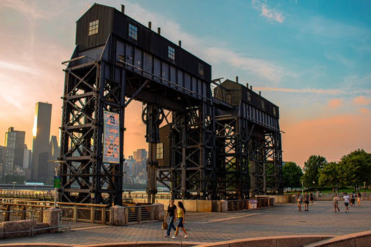 The towering industrial structures stand as silent sentinels against the vibrant hues of a New York...