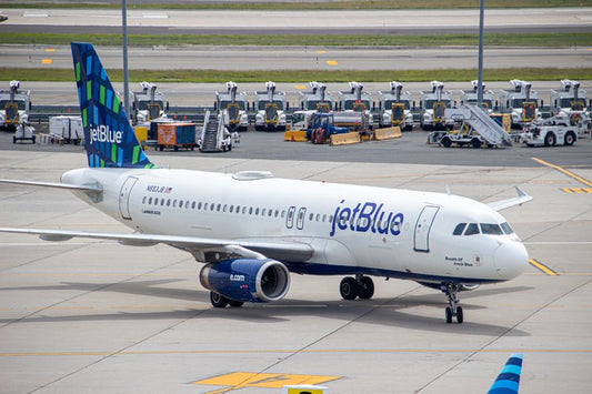A jetBlue airplane stands poised on the tarmac, its sleek design harmonizing with the orderly rows...