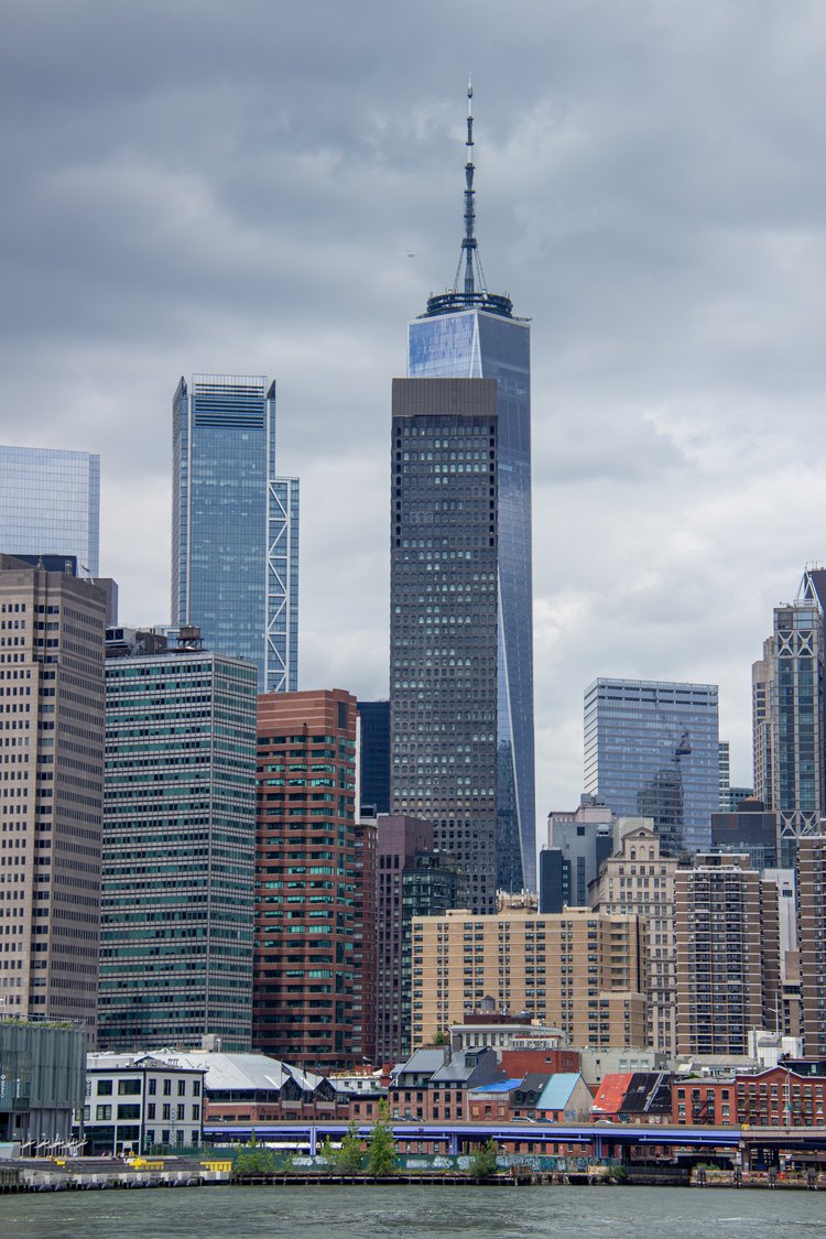 This striking image features the iconic skyline of Lower Manhattan, where towering skyscrapers...