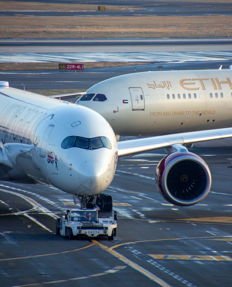 Two majestic aircrafts grace the runway, their sleek forms poised in a delicate dance of aviation