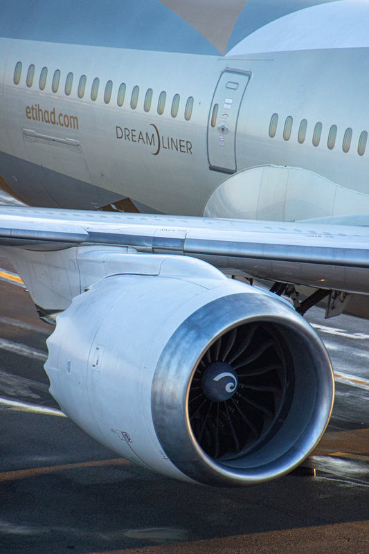 This image captures the sleek form of a modern aircraft, the Dreamliner, as it rests on the tarmac
