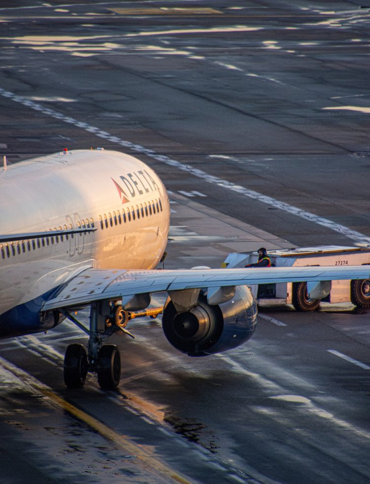 A commercial airplane is captured in a moment of quiet anticipation, poised on the tarmac under the...