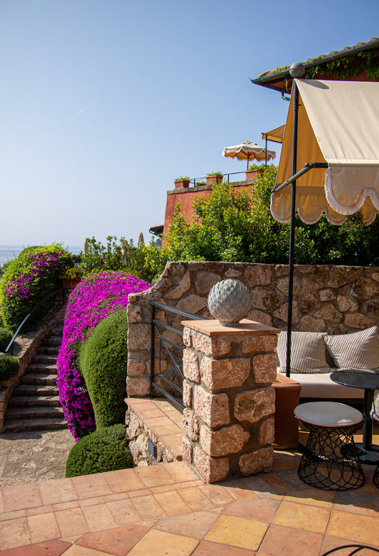 Basking in the gentle warmth of the Italian sun, this terrace scene captures the timeless elegance...