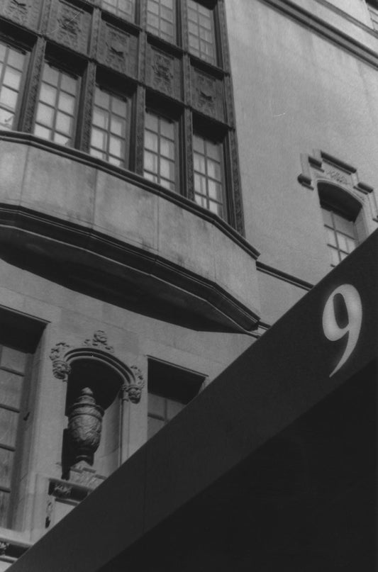 A prominent number nine adorns the awning, leading the eye to the intricate façade of an Upper East...